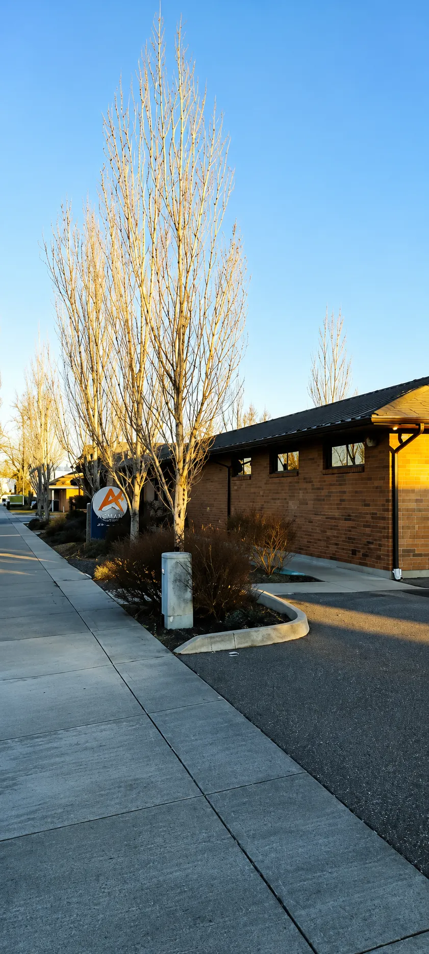 The ACMAN Solutions office building exterior in Pasco, Washington at golden hour